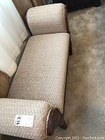 Full view of upholstered wooden bench showing seat, backrest, and armrests