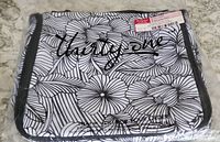 Front of the Thirty-One brand hanging traveler case showing floral pattern and branding.