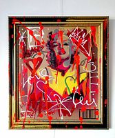 Frontal view of framed artwork showing the full stencil portrait with red drips and graffiti