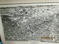 Black and white bird's eye view of 1909 Los Angeles city map showing street and buildings detail with surrounding mountains.