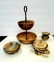 Full lot view showing two-tier Myrtle Wood bowl set in front, miniature brass spittoon candle holder, and two brass fire alarm bells behind.
