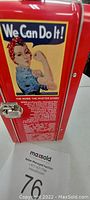 Close-up of the lunchbox front panel showing 'We Can Do It!' Rosie the Riveter poster with text about Rosie the Riveter story.