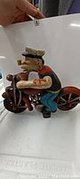 Side view of Popeye the Sailor riding the motorcycle showing the detail in paint and positioning
