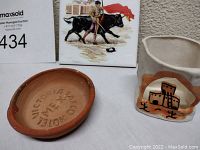 Photo showing the terracotta stone ashtray, the handmade clay candle burner with pueblo design, and the painted tile with bullfighter and bull.