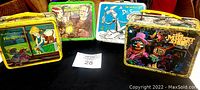 Group of five lunchboxes: Rescuers, Universal Monsters, Dr. Seuss, The Muppet Show, Aladdin