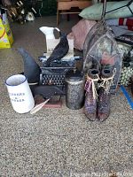 Lot items on garage floor: witch boots, typewriter, black crow, ceramic pitcher, canister, ceramic pot, terrarium
