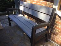 Side angle showing full length and design of bench and its weathered condition