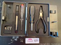 Tool set including screwdriver, pliers, retractable knife, and bits in plastic case