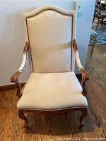 Full front view of chair showing high back, curved arms and seat