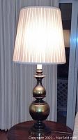 Lamp turned off showing brass body and shade details