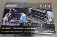 Box showing the Char-Broil portable gas grill, image of assembled grill, and highlighting easy assembly