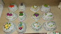 Set of 13 Franklin Mint Le Cordon Bleu porcelain wall gelatin molds arranged on a countertop showing various fruit and vegetable designs in colorful hand-painted detail.