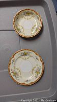 Small plate and matching smaller bowl showing floral pattern with gold trim, part of Noritake Blakely set.