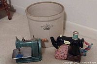 Full view including Blue Crown crock, metal hand crank sewing machine, and tea kettle shaped like a sewing machine.