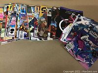 Photo showing a laid out spread of various Marvel comic books including X-Men, Spider-Man, and Strange Tales issues.