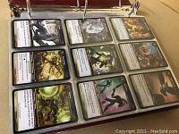 Open binder page showing 9 World of Warcraft trading cards in UltraPro sleeve, front side visible with character art and card text.