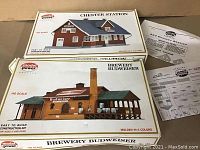 Two unopened model kits in original boxes with instruction sheets, Budweiser Brewery and Chester Station, both HO scale by Model Power.