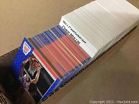 Photo showing a thick stack of basketball cards sorted alphabetically by player last names, with several cards clearly visible and the rest stacked behind them.