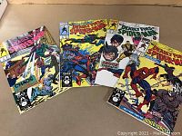 Photo showing the full set of four Deadly Foes of Spider-Man comics displayed side by side on a surface. Covers feature Spider-Man battling various enemies including Rhino and Scorpion.