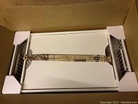 Photo of white breakfast tray fully packed in original cardboard box with protective corner styrofoam pieces visible.