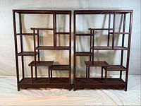 Front view of both curio shelves side by side on white backdrop