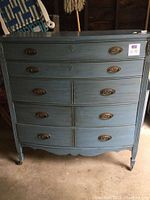 Front-facing view of the dresser showing all 5 drawers and hardware details.