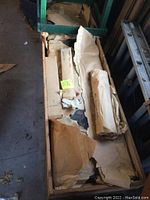 Crated Japanese screen covered in paper packaging inside a wooden shipping crate.