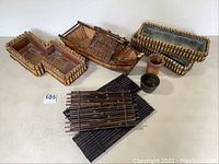Full lot overview showing all 9 pieces including bamboo boat, rectangular containers, wooden bucket, metal container, and bamboo mats.