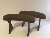 Two upholstered Japanese kyosoku armrests placed side by side on a white surface showing overall shape and proportion.