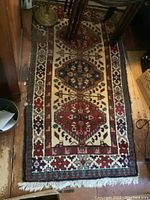 Full view of the Oriental carpet showing the central geometric medallions and border pattern.