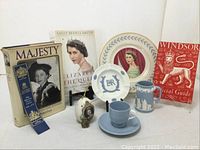 Full lot with all 10 items including books, plates, ashtray, pitcher and teacup, pomander, bookmark, and coin