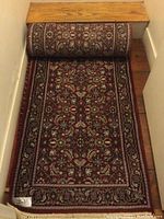 Partially unrolled runner showing full width and pattern at top of stairs