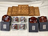 Overall view of the tea cups, wooden coasters, and bamboo trivets arranged for sale.