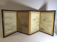 Full view of the four-panel folding table screen showing landscape and floral paintings with gold borders.