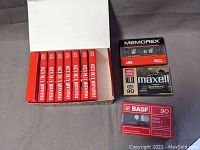 Overview of all 11 cassette tapes showing 9 Maxell UR 120 in box, 1 BASF Ferro Extra 90, and 1 Memorex DB 60, all sealed in original packaging