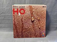 Front cover of the Hall & Oates 'H2O' vinyl LP album showing textured water droplet design and red text.