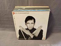 Front view of Pete Townshend Chinese Eyes vinyl record cover showing black and white portrait of the artist with wooden props crossed over chest.