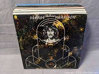 Front cover of a George Harrison vinyl record with an outer space themed design