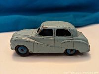 Side view of light blue Austin Somerset Dinky Toy model car showing paint chipping and wear.