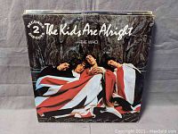 Photo of 'The Kids Are Alright' double album vinyl record cover showing band members wrapped in a Union Jack flag.