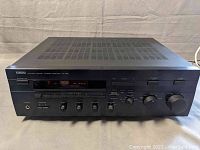 Front view of Yamaha RX-596 stereo receiver showing overall condition and vented top panel.