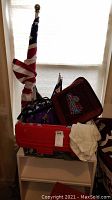 Full view of items including US flag, Huskies blanket, box, and bags