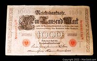 Front view of the 1910 German 1000 Marks banknote showing serial number, date, and ornate black and red design.