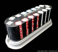 Poker chip set arranged in rack, showing four vertical columns of chips grouped by color: white, red, blue, black. Chips are 11.5 grams with WPT logo in center.