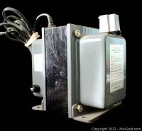 Side view of the autotransformer showing power cord, metal base, and outlet.