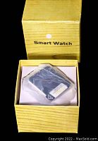 Smart watch in original yellow box labeled 'Smart Watch'.