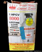 Front of the box showing the Waste King Legend Series 8000 1 HP food waste disposer with details about lifetime home service warranty and power cord included.
