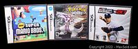 Front view of three Nintendo DS game cases: New Super Mario Bros, Pokemon Pearl Version, and MLB 2K7