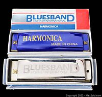 Two Bluesband Hohner International harmonicas in their boxes: one blue plastic comb NOS, one metal comb used with chrome covers.