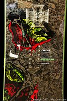 Close-up view of snowboard top with graphic details and silver cross emblem.